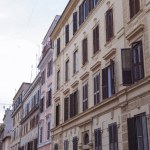 Ancient building on street of Rome on cloudy day, Italy