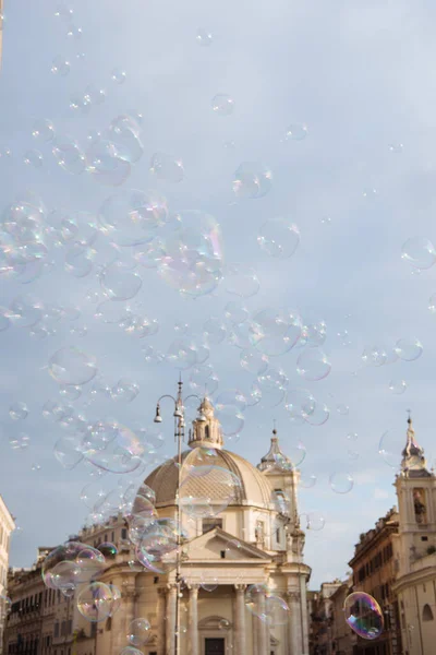 obelisk at piazza del popolo (peoples square) and soap bubbles in Rome, Italy