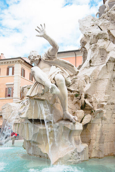 statues on Fountain of Four Rivers and obelisk in Rome, Italy
