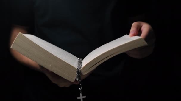 女性在黑色背景下阅读圣经的特写镜头 — 图库视频影像