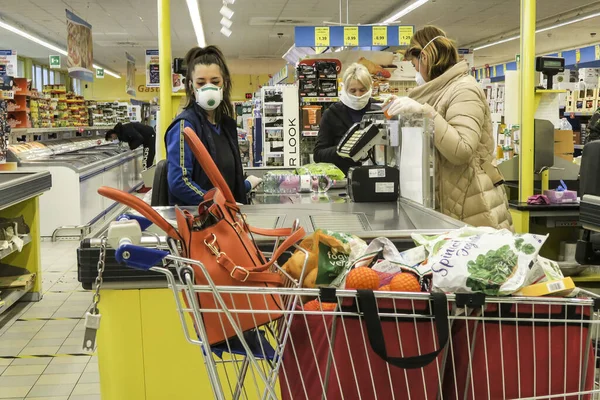 12/03/2020 Paina, Monza Brianza, Lombardy, Italy.  - Coronavirus. People wearing protective face masks in supermarket.