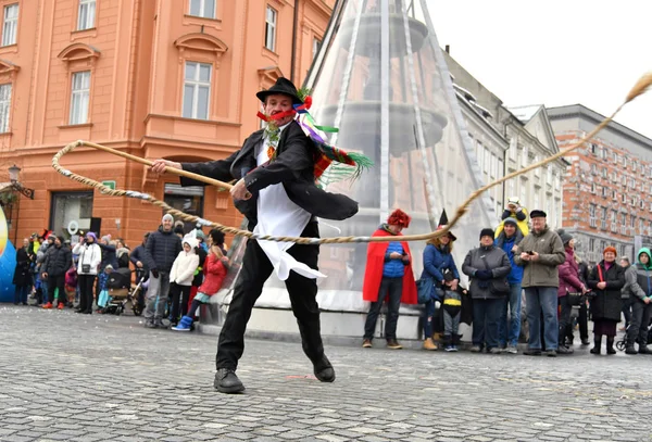 Traditional carnival on shrove Saturday and person with big rope-made whip, which creates loud bang, Ljubljana, Slovenia — Stock Photo, Image