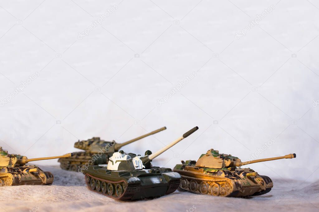 Toy tanks on a white background .