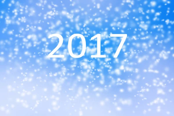 Feliz año nuevo 2017 fondo de tormenta de nieve borrosa en el cielo azul — Foto de Stock