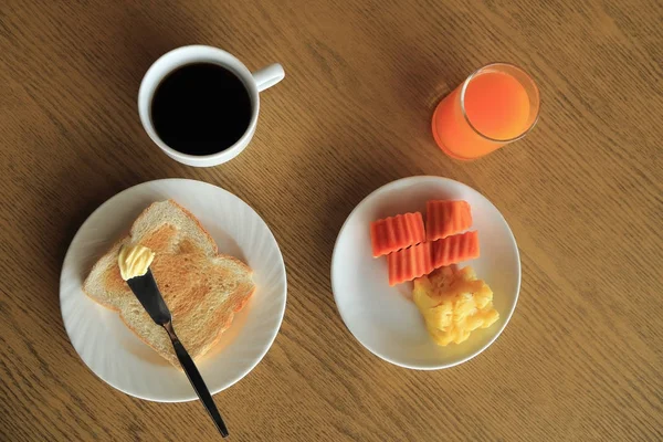 Set of breakfast, plate of toast with butter, fresh fruit, cup of black coffee and orange juice — Stock Photo, Image