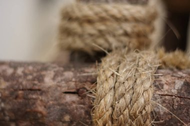 Abstract background of blurred rope wrapped around log. clipart