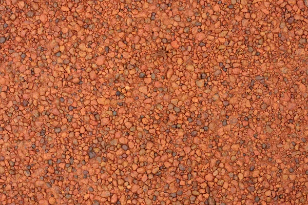 Red laterite gravel texture for background. Stock Picture