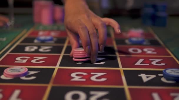男性と女性はルーレットベットをカジノテーブルの近くに置いて — ストック動画