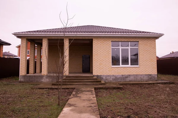 Single storey house. Isolated single storey house. Front View of one floor single family house.