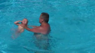 Baba ve kızı havuzda. Baba kız bebek yüzmeyi öğret