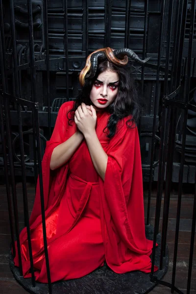 Woman in cage with snake.