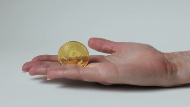 Female Hand Holds Gold Bitcoin White Background — Stock Video