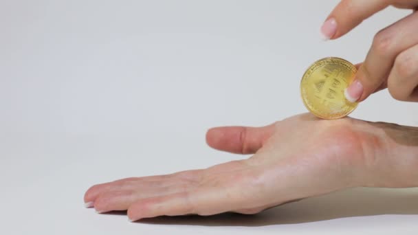 Golden Bitcoin Slides Female Palm — Stock Video