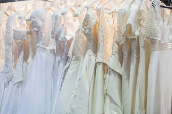 Beautiful wedding dresses hang on hangers. — Stock Photo, Image