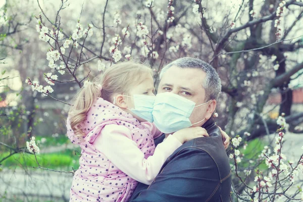 Daughter and dad wearing masks on the street. Pandemic virus.