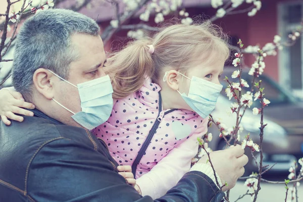 Kızı ve babası sokakta maske takıyor. Salgın virüsü.