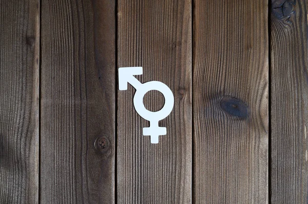 symbol for gender equality cut out of paper on a wooden background