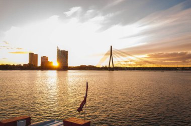 Riga, Latvia September 13, 2018: Sunset on River Daugava with bridge and city skyline in the background
