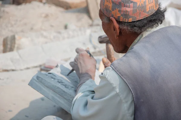 Kathmandu, Nepal - February 25, 2018: Stone carver working on his craft