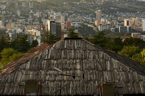A view of Tbilisi, Georgia overlooking the wooden rooftop of an old house