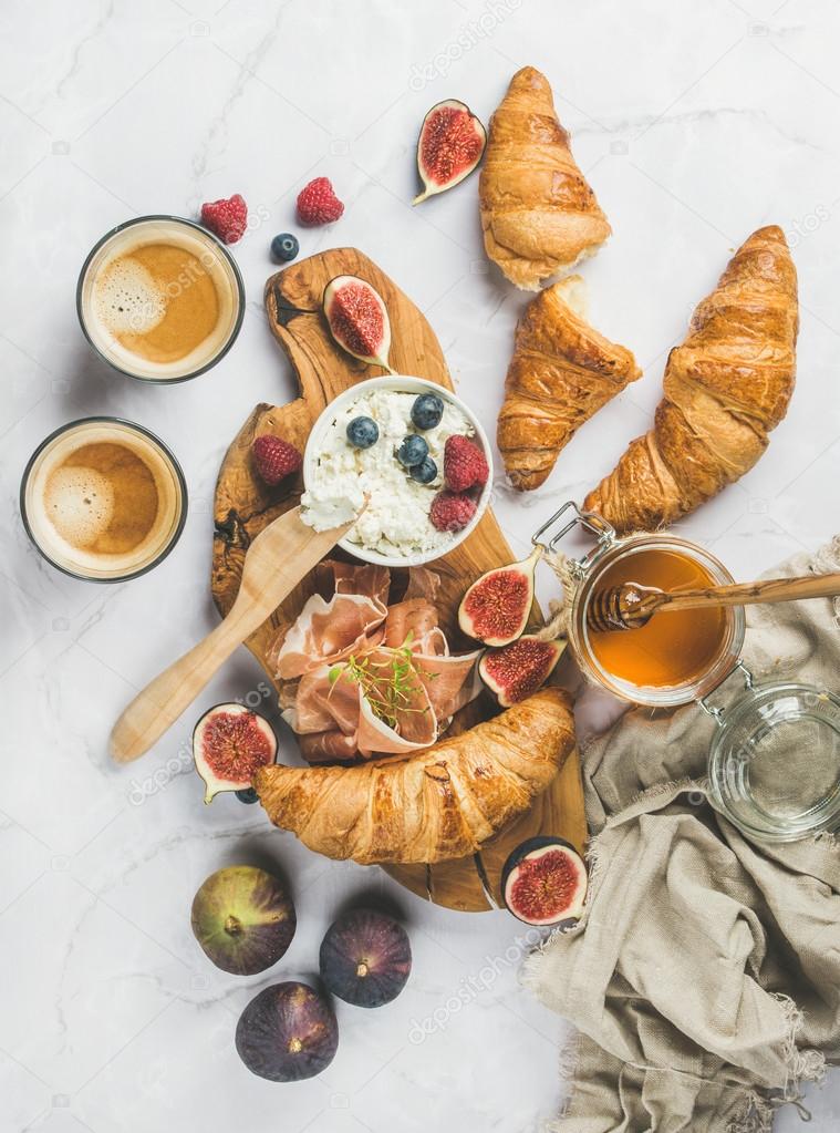 Breakfast with croissants, ricotta, coffee and berries