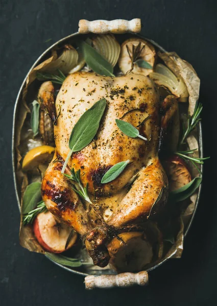 Oven roasted whole chicken with onion, apples and sage