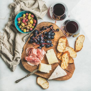 Çeşitli aperatifler ve kırmızı şarap gözlük