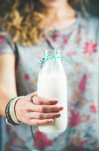 Женщина держит бутылку молока — стоковое фото