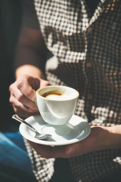 Cup of coffee in man's hands