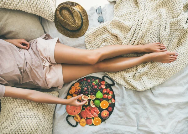 Girl taking fruit from tray — Stock Photo, Image