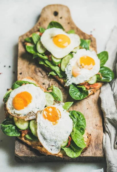 Bread toasts with fried eggs