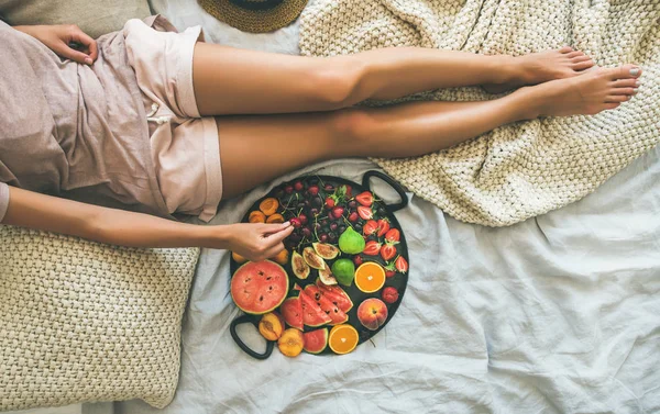 Girl with tray full of seasonal fruits — Stock Photo, Image