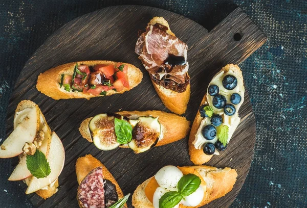 Italian crostini with various toppings — Stock Photo, Image