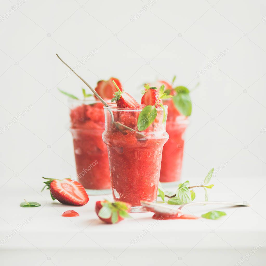 Healthy low calorie summer treat. Strawberry and champagne granita, slushie or shaved ice dessert in glasses, white background