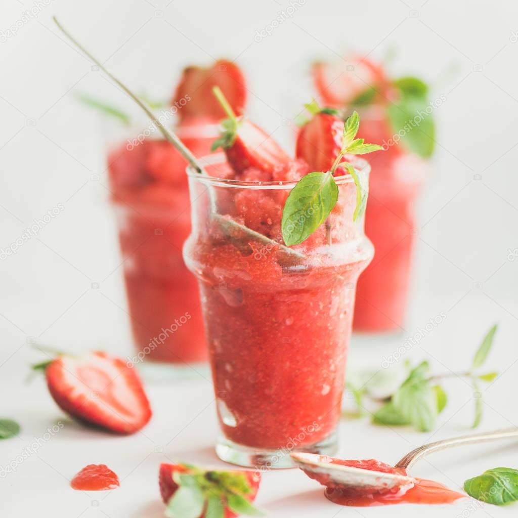 Healthy low calorie summer treat. Strawberry and champaigne granita, slushie or shaved ice dessert in glasses, white background