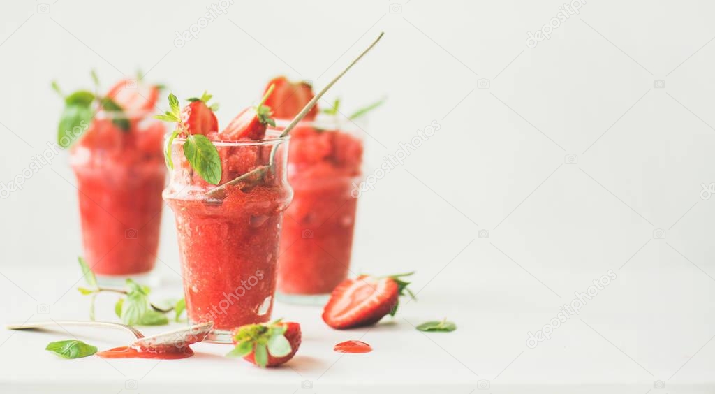 Healthy low calorie summer treat. Strawberry and champaigne granita, slushie or shaved ice dessert in glasses, white background