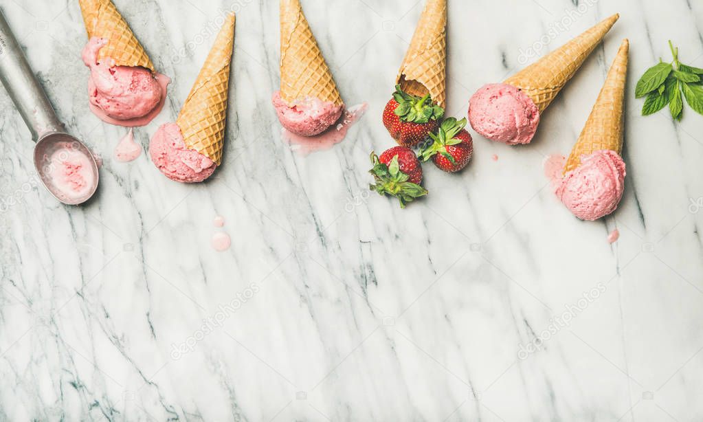 Healthy low calorie summer dessert. Homemade yogurt ice cream with strawberries in waffle cones