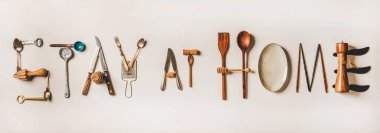 Stay at home lettering made from various kitchen utensils, top view. Flat lay of stay at home words for quarantine isolation during coronavirus infection pandemic. Banner for website for food shop clipart