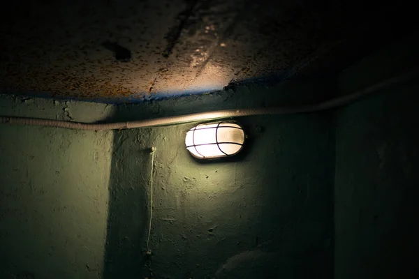 Lantern on the wall in a bunker underground
