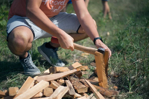 Man chopping wood with an ax on the street