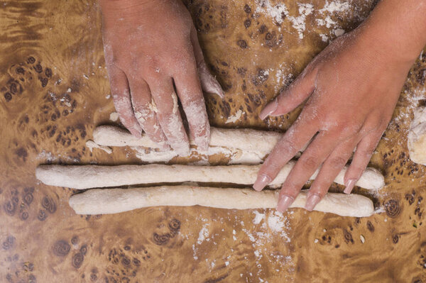 two hands making pasta. hands preparing gnocchi