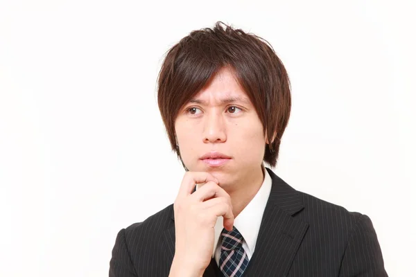 Giovane imprenditore giapponese pensa a qualcosa — Foto Stock