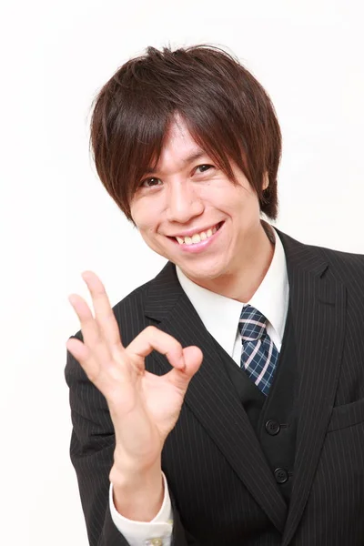 Young Japanese businessman showing perfect sign — Stock Photo, Image