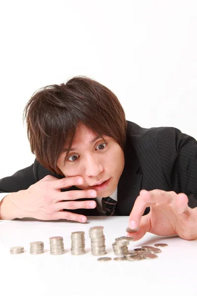 Stack of coins collapsed when businessman put a coin — Stock Photo, Image