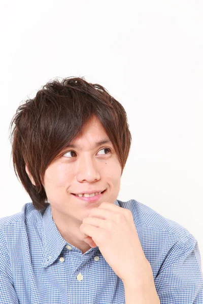 Young Japanese man thinks about something — Stock Photo, Image