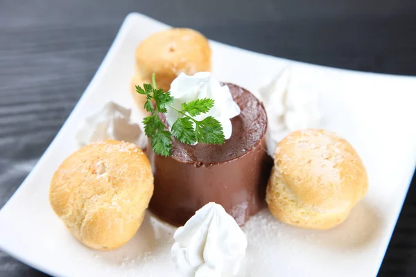 Chocolate pudding with cream puffs — Stock Photo, Image