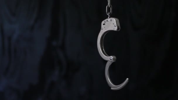 Unlocked Handcuffs Swinging Dark Background — Stock Video