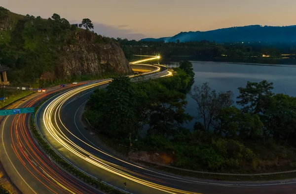 highway light trails of vehicles lights during rush hour and sunset