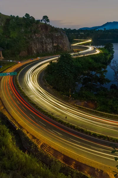 highway light trails of vehicles lights during rush hour and sunset
