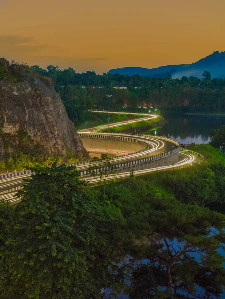 highway light trails of vehicles lights during rush hour and sunset